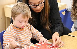 Teacher helps young student