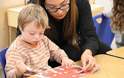 Teacher helps young student