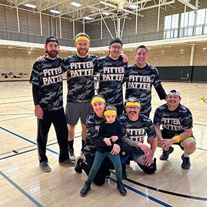 group poses on basketball court