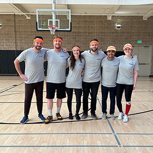 group poses on basketball court