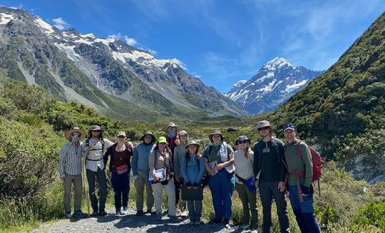 group of people in front of mountains