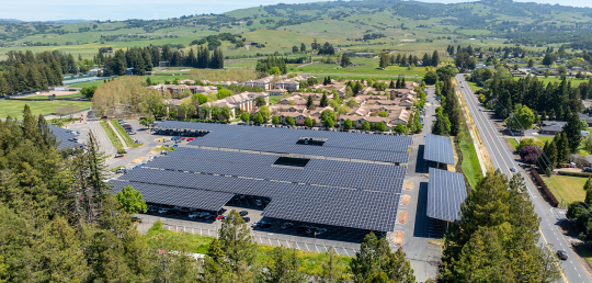aerial view of solar panels over parking lot