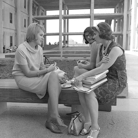 3 students seated on a bench