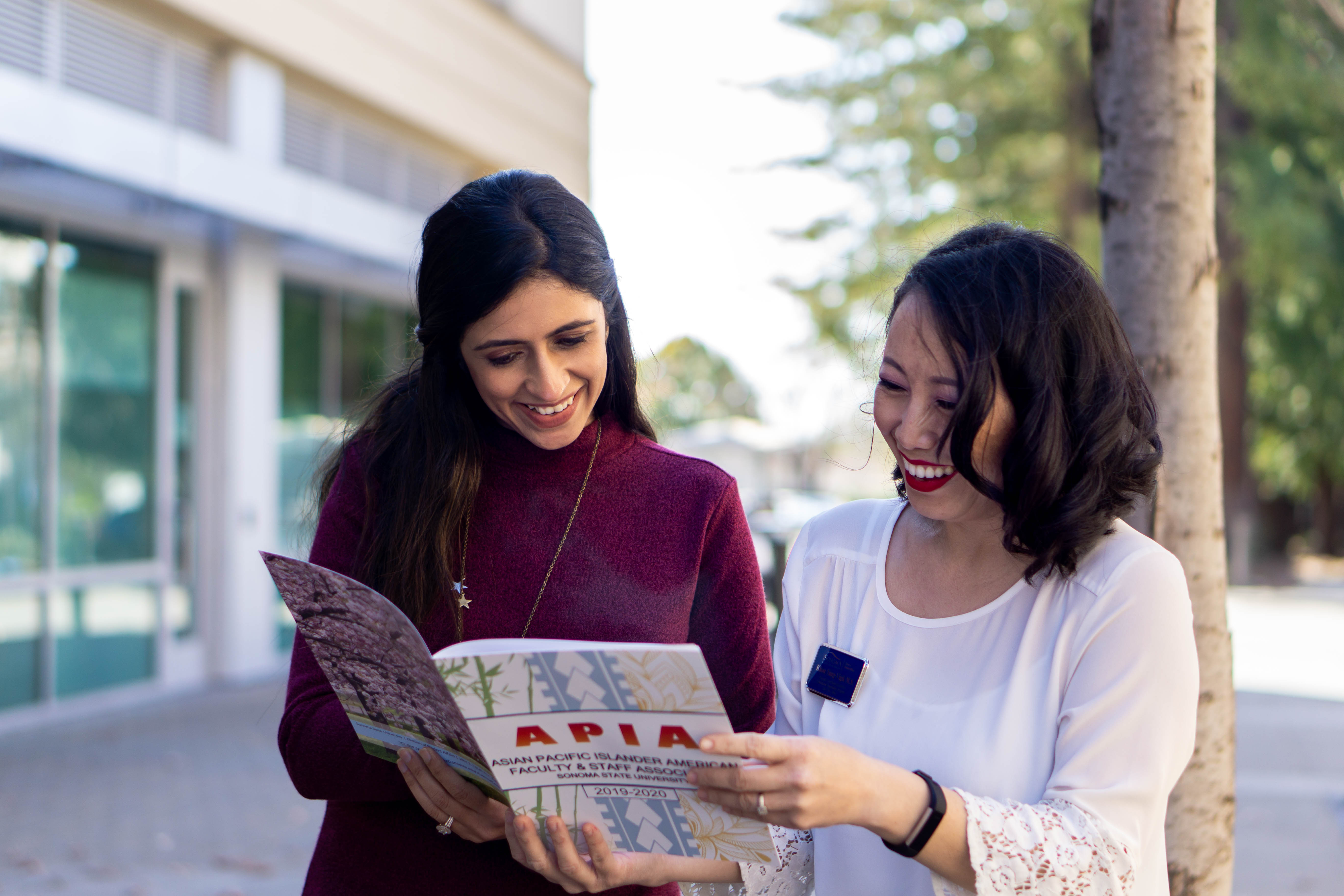 Two people sharing a magazine 